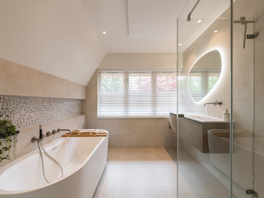 Attic bathroom with freestanding bath, pebble stone niche and organic mirror, Huizen